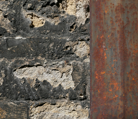 Old stone wall reinforced with metal plates closeup architectural detail backgroundの写真素材