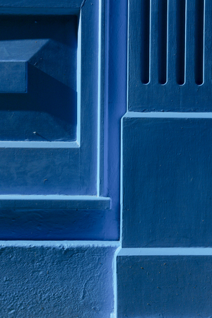 Blue painted wood and concrete in sun with shadows backgroundの写真素材