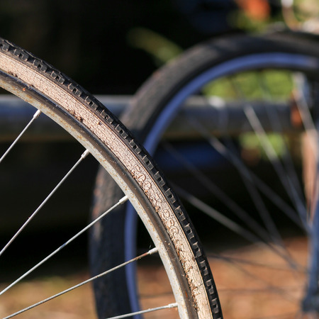 Close up shot of old bicycle wheel rim with tire on dark backgroundの写真素材