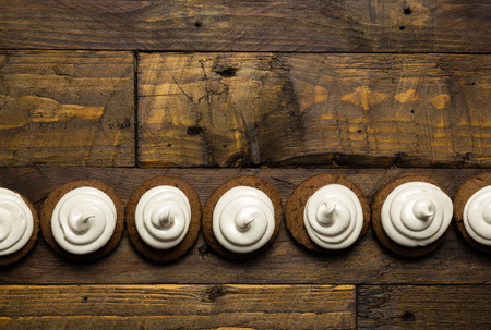 Hot chocolate cookies with marshmallow meringue on dark brown rustic wood backgroundの写真素材