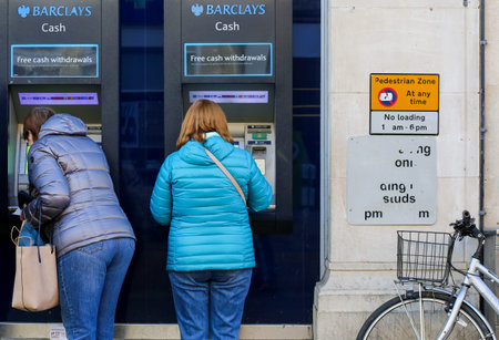 Cornmarket Street, Oxford, United Kingdom, January 22, 2017: Customers using a Barclays Bank ATM...
