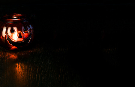 Halloween pumpkin head bowl lantern on dark background with copy spaceの写真素材