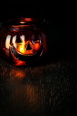 Halloween pumpkin head bowl lantern on dark background with copy spaceの写真素材