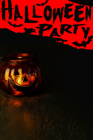 Halloween party invitation concept, pumpkin head bowl lantern on dark background with copy spaceの写真素材
