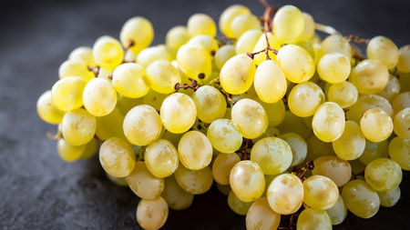 Close-Up of Fresh Green Grapes on Dark Background, Stylish Blur Depth of Fieldの写真素材