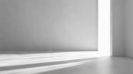 Minimal White Interior with Sunlight Streaming Through Vertical Window Openingの写真素材