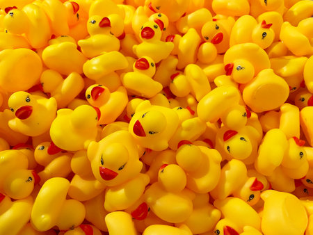 Bright Abstract Pattern of Mini Yellow Rubber Ducks with Red Beaksの写真素材
