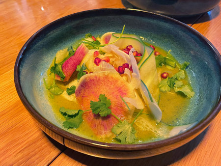 Fresh Salad with Watermelon Radish, Pomegranate, and Herbs in Citrus Vinaigretteの写真素材