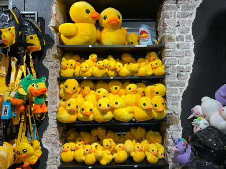 Shelf Full of Yellow Duck Plush Toys and Accessories at The Rubber Duck Store, Maastrichtの写真素材