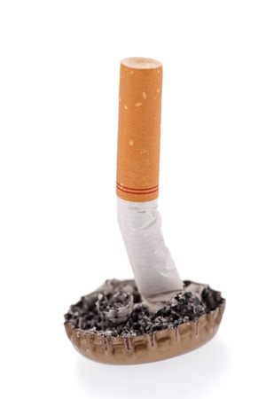 Quit smoking, cigarette butt in a bottle cap on white backgroundの写真素材