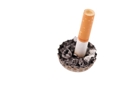 Quit smoking, cigarette butt in a bottle cap on white backgroundの写真素材