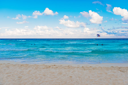 Cancun, Mexico - August 30, 2013  People flying parachute over Caribbean sea in Cancun, Mexico on August 30, 2013 