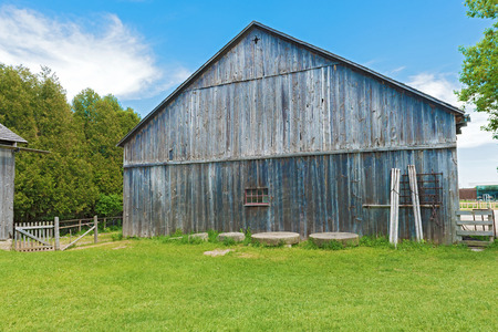 Back wall of old wooden barn  against a blue sky  の写真素材