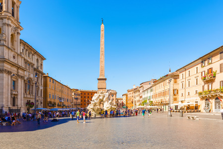Rome, Italy - August 29, 2014: Tourists visiting Piazza Navona in Rome. Fountain dei Fiumi. Pope Innocent X originally commissioned the work from Francesco Borromini. He completed the fountain in 1651.のeditorial素材