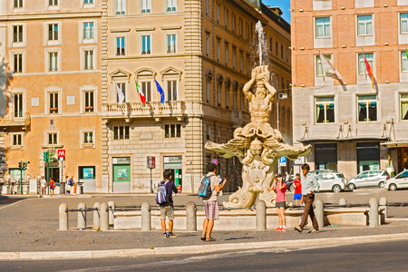 Rome, Italy - August 29, 2014: Tourists walking by Fountain del Tritone at Piazza Barberini in Rome, Italy.のeditorial素材