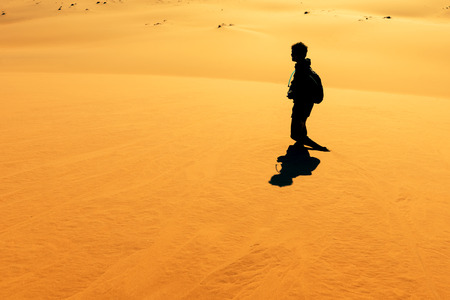 Sossusvlei, Namibia - April 26, 2015: Early morning at Sand Dune in the Namibian Desert near Sossusvlei. People are climbing dunes to view magnificent sunrise over the dunes.の写真素材