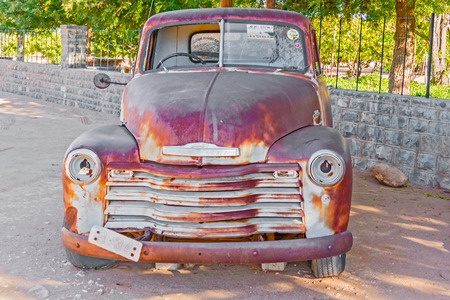 Helmeringhousen, Namibia - April 28. 2015: Old rusty car on a sidewalk in Helmeringhousen, Namibia.のeditorial素材