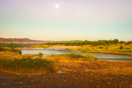 Scenic sunset view at the Orange river in Noordoewer in Namibia at Felix Unite Camp on May 2, 2015の写真素材