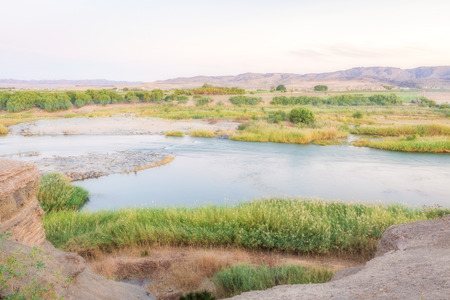 Scenic daylight view at the Orange river in Noordoewer in Namibia at Felix Unite Camp on May 1, 2015の写真素材