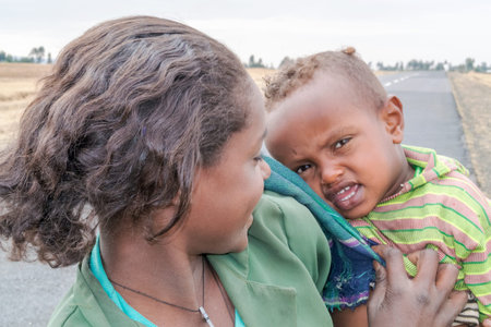 Gebre Guracha, Ethiopia - February 16, 2015: Close up picture of the young girl staying by the road...
