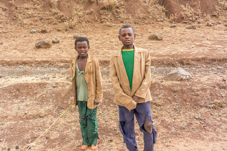Ali Doro, Ethiopia - February 16, 2015: Close up picture of the young boys staying by the road. Picture was taken when riding on the road number 3 near Ali Doro in Ethiopia.のeditorial素材
