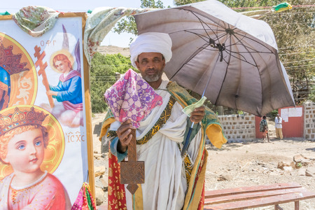 Addis Zemen, Ethiopia - February 10, 2015: Close up picture of thepriest wth umbrella. He was collecting money for new church. Picture was taken in Addis Zemen in Ethiopia.のeditorial素材