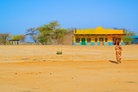 Namunyak, Kenya - March 4, 2015: Local woman walking towards hotel. Picture was taken in Namunyak Wildlife in Kenya at the road A2.のeditorial素材