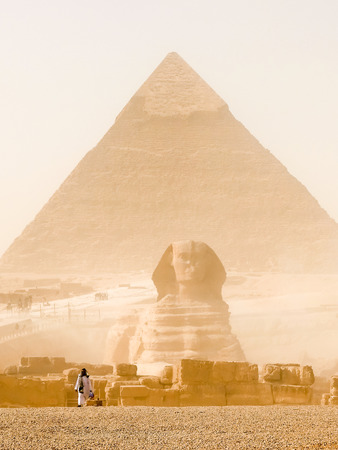 Cairo, Egypt - January 6, 2015: Local man walking in front of Sphinx and pyramid of Gizaのeditorial素材