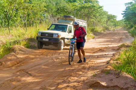 Ilungu, Tanzania - March 19, 2015: Man on the bicycle travelling in Tanzania. Picture taken on the road near Ilungu in Tanzania.のeditorial素材
