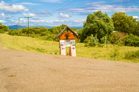 Ngara, Malawi - March 23, 2015: Sign at the road pointing direction to the lodge located on the lake Malawi in Malawi.のeditorial素材