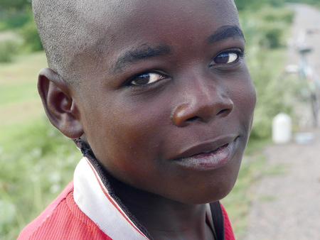 Lupembe, Malawi - March 23, 2015: Picture of the young boy at the road in a small village in Lupembe Malawi.のeditorial素材