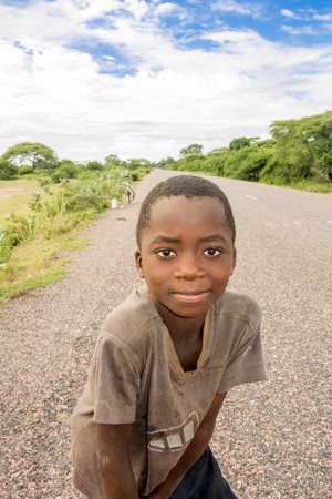 Lupembe, Malawi - March 23, 2015: Picture of the young boy at the road in a small village in Lupembe Malawi.のeditorial素材