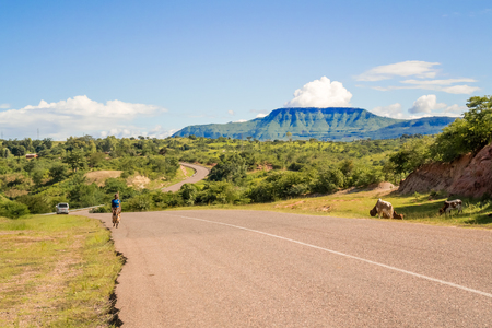 Karonga, Malawi - March 23, 2015: Local woman walking on the road in Karonga in Malawi.のeditorial素材