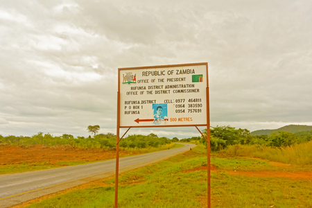 Rufunsa, Zambia - April 2, 2015: Road sign pointing to district office in Zambia.のeditorial素材