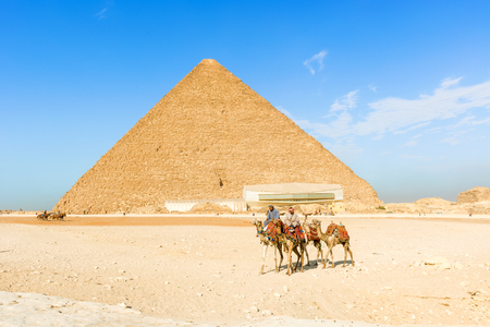 Cairo, Egypt - December 31, 2014: Pyramids in Giza and the men on camelsのeditorial素材