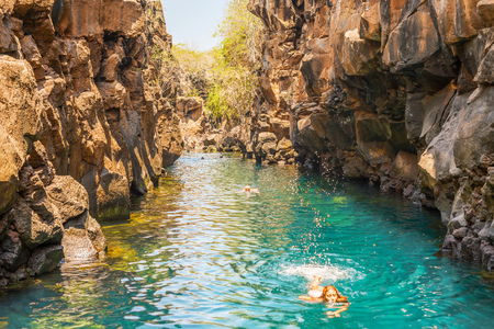 Puerto Ayora, Galapagos, Ecuador - April 2, 2016: People are swimming in  Las Grietas on Santa Cruz Island in Galapagos. It is popular tourist destination on Santa Cruz Island.のeditorial素材