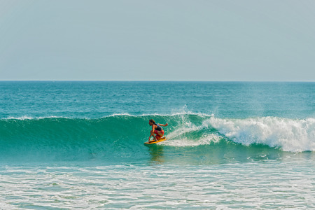 Plya Venao, Panama - March 23, 2016: Man surfing in the Pacific ocean in Playa Venao near Pedasi in Panama.のeditorial素材