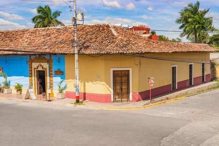 Granada, Nicaragua - November 20, 2016: Street view at the facade of colorful comercial houses in...