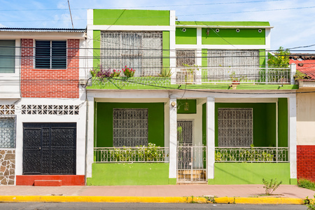 Street view at the facade of colorful houses in the historic district of Granada in Nicaraguaの写真素材