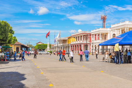 Granada, Nicaragua - November 20, 2016: People walking in Cathedral Plaza in front of historical colonial buildings of the town of Granada in Nicaragua.のeditorial素材