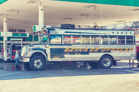 Chinique, Guatemala - December 9, 2016: Colorful bus at the gas station in small town of Chinique in Guatemalaのeditorial素材