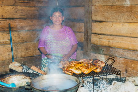 Chisec, Guatemala - December11, 2016: Woman is preparing meal in the kitchen in countryside of Guatemala near small town of Chisec.のeditorial素材