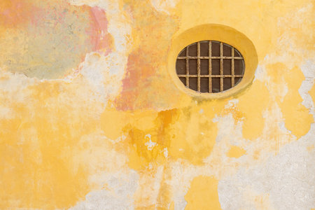 Colorful old wall and Round window in historic part of Cartagena, Colombia