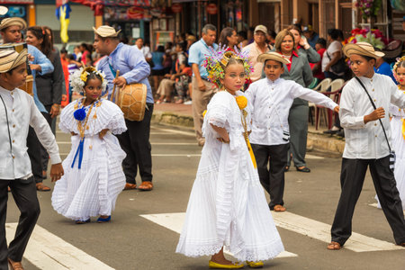 Chitre, Panama - November 19, 2016: Dressed in traditional pollera costume, girls marching in parade in Chitre the capital of the province of Herrera Panama in Azuero Peninsula.のeditorial素材