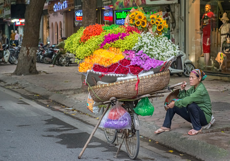 Hanoi, Vietnam - October 27, 2017: Street vendor in Hanoi, Vietnam is selling flowers from his bicycle.のeditorial素材