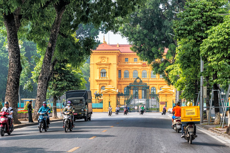 Hanoi, Vietnam - October 27, 2017: People riding motorbikes on the street in front of the entrance to the Presidential Palace of Vietnam in Hanoi.のeditorial素材