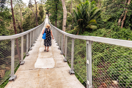 George Town, Penang, Malaysia: Woman crossing the hanging bridge in the Habitat  Penang Hill on Canopy Walk Penang, Malaysia.の写真素材