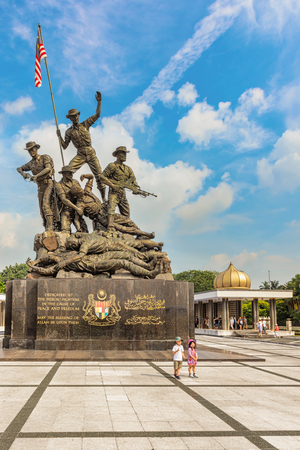 Kuala Lumpur, Malaysia â Dec 14, 2017: Tourists visiting National Monument, sculpture that commemorates those who died in Malaysia struggle for freedom, against Japanese during World Wars.のeditorial素材