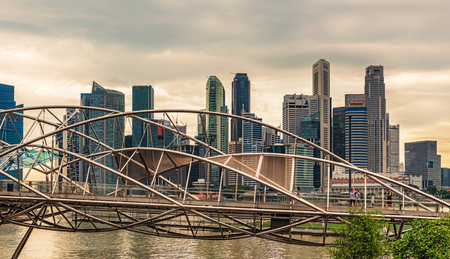 Singapore - Jan 10, 2017: Landscape view at downtown skyscrapers skyline and the modern Helix walkway bridge over Marina Bay in Singapore.のeditorial素材