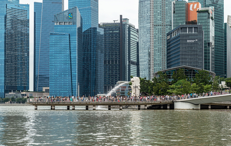 Singapore - Jan 14, 2018: Tourists visiting The Merlion fountain at Marina Bay. The Merlion is a marketing icon used as a mascot and national personification of Singapore.のeditorial素材